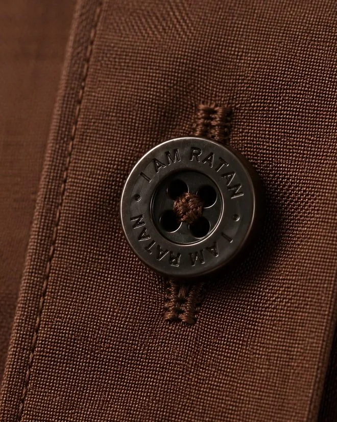 A button with I AM RATAN engraved around the rim